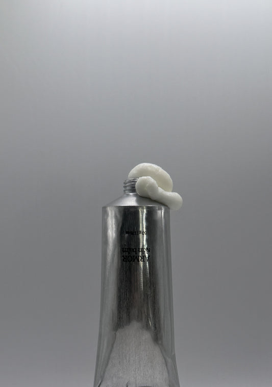 Metallic bottle with a white cap on a gray background