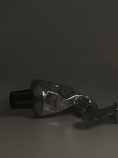 Metallic tube with a nozzle on a dark background