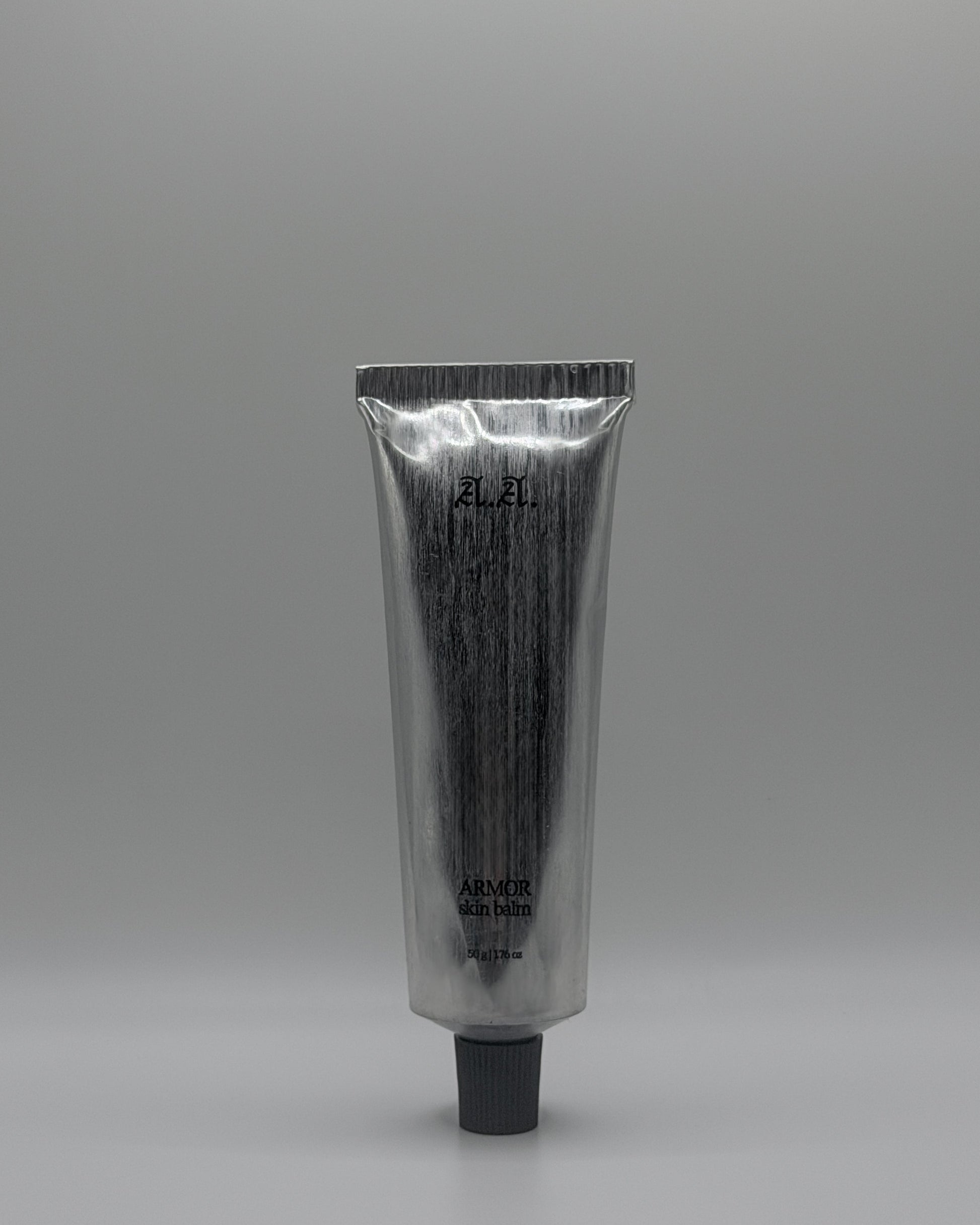 Silver tube with black cap on a gray background