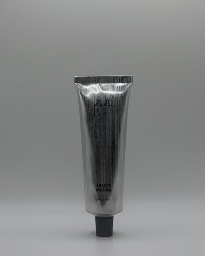 Silver tube with black cap on a gray background