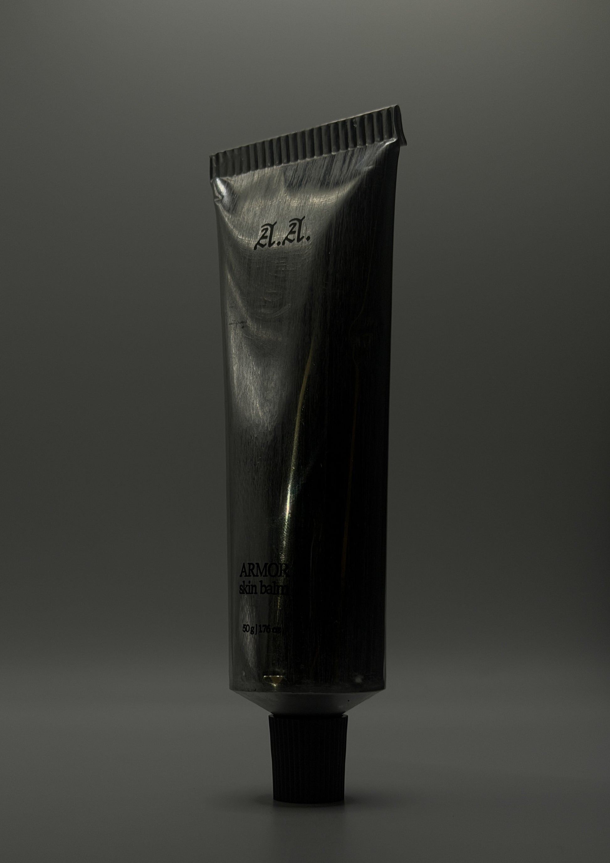 Black tube with 'A.A.' branding on a gray background