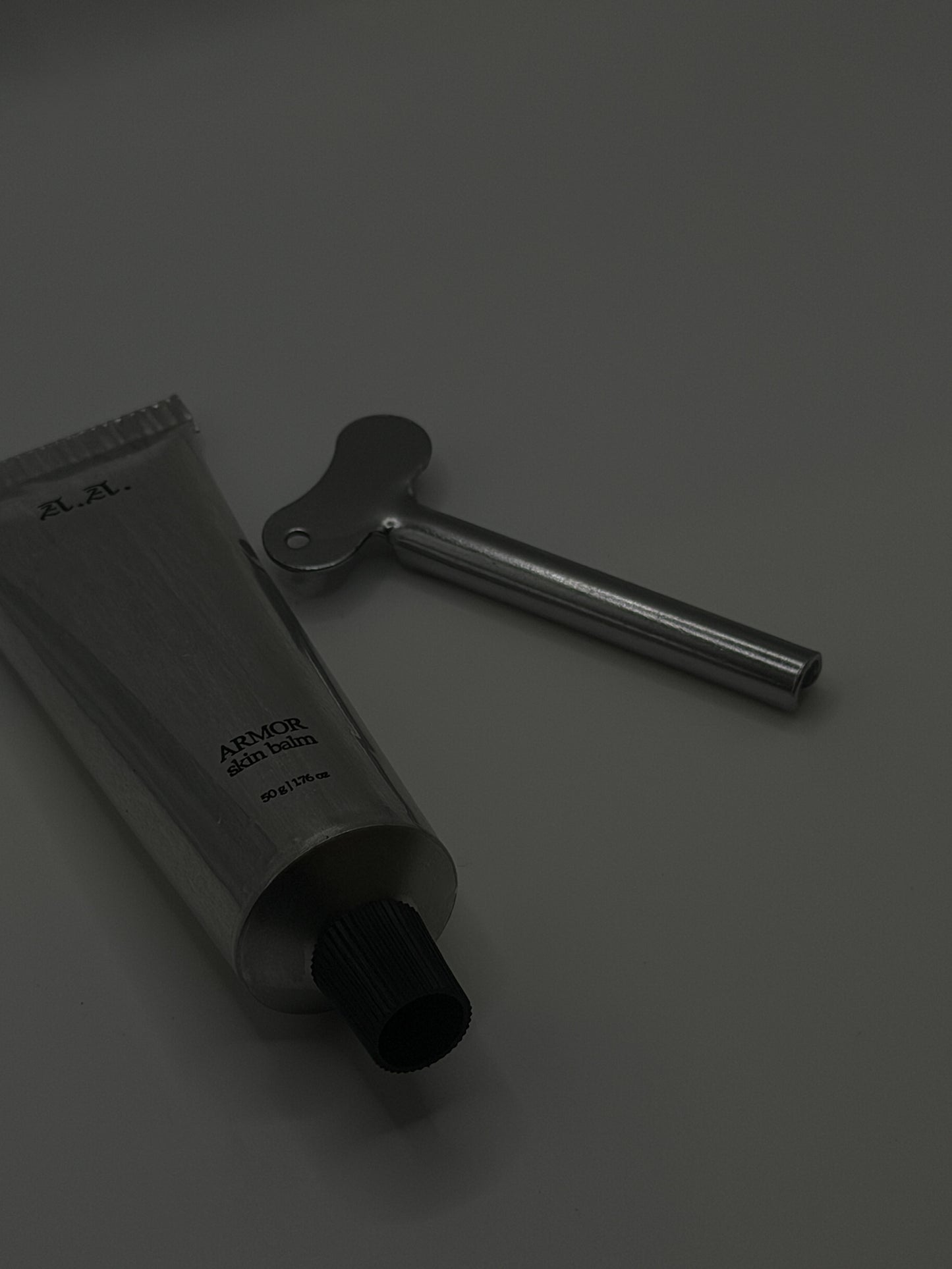 Black tube and tool on a gray background