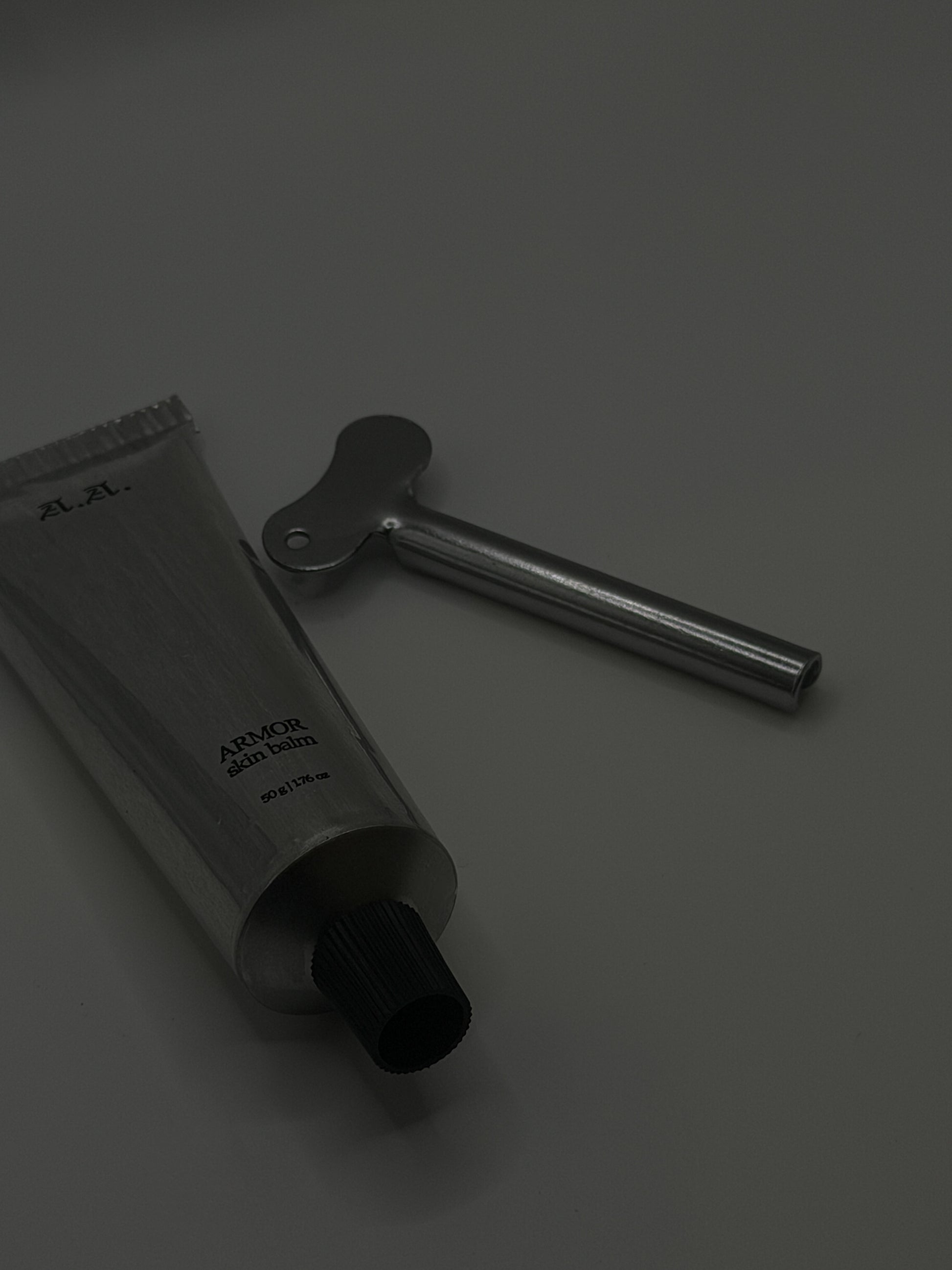Black tube and tool on a gray background