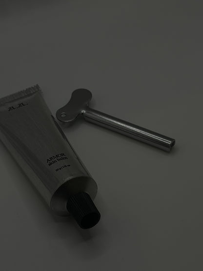 Black tube and tool on a gray background